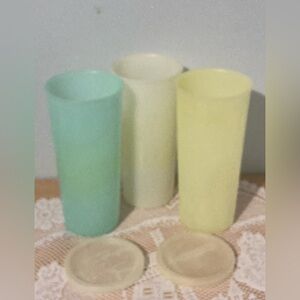 Three vintage 12-ounce Tupperware drinking glasses and two lids